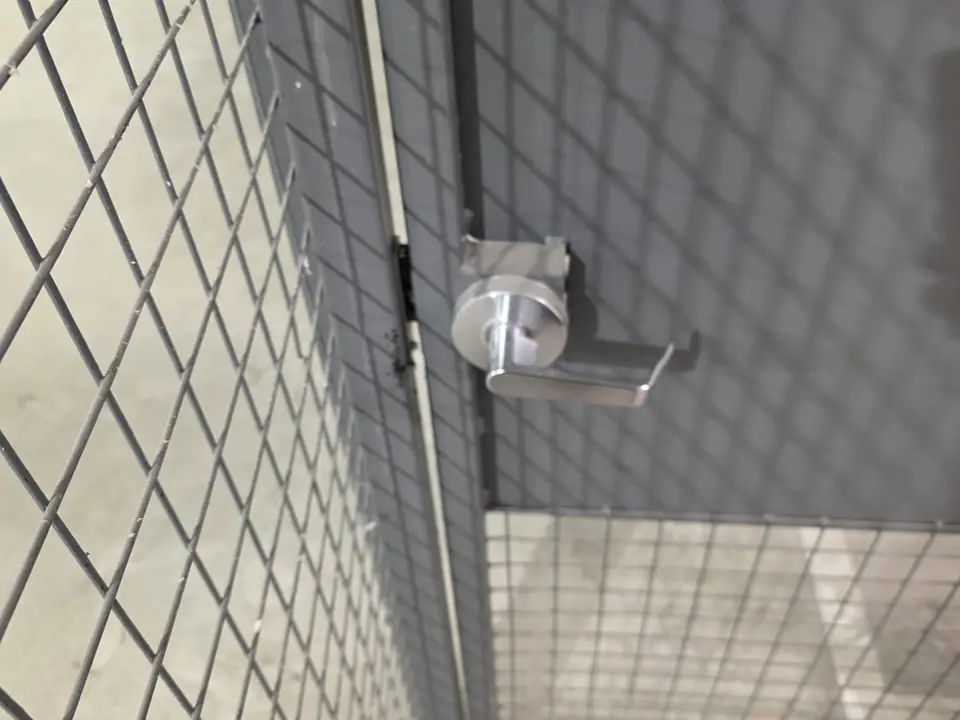 Lever handle lock on a wire mesh gate
