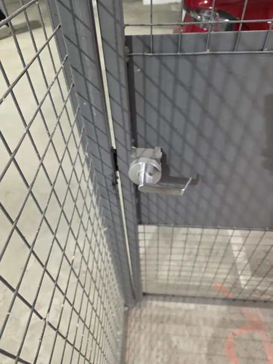 Lever handle lock on a wire mesh storage cage door