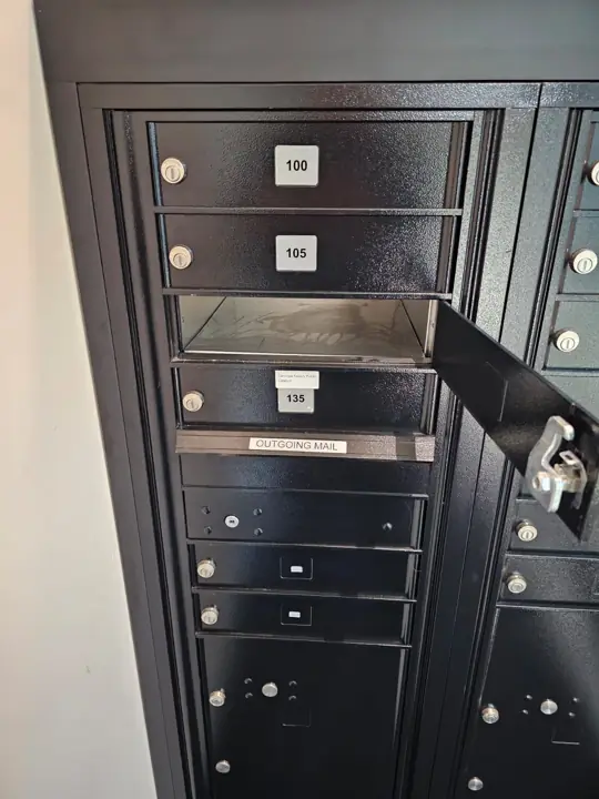 Lock-box mailbox bank with one compartment door open
