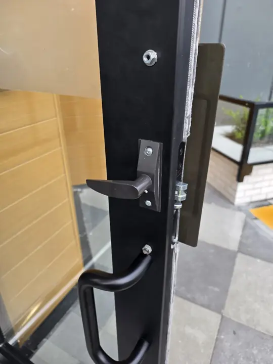 Black storefront door handle and latch hardware