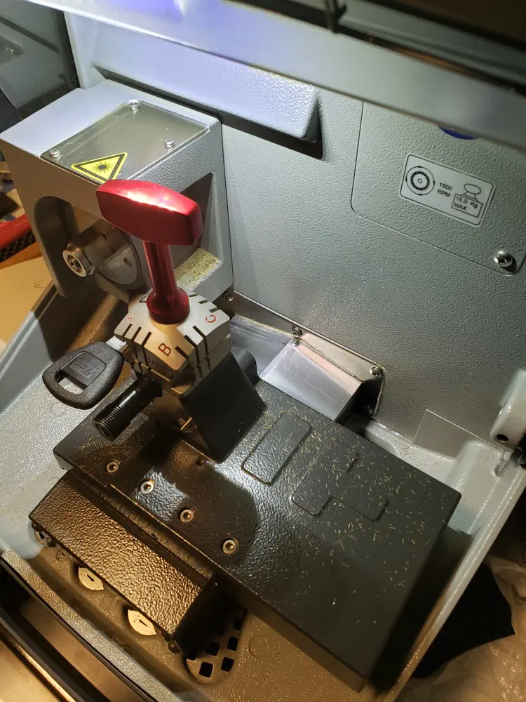 Key cutting machine with a key clamped in place